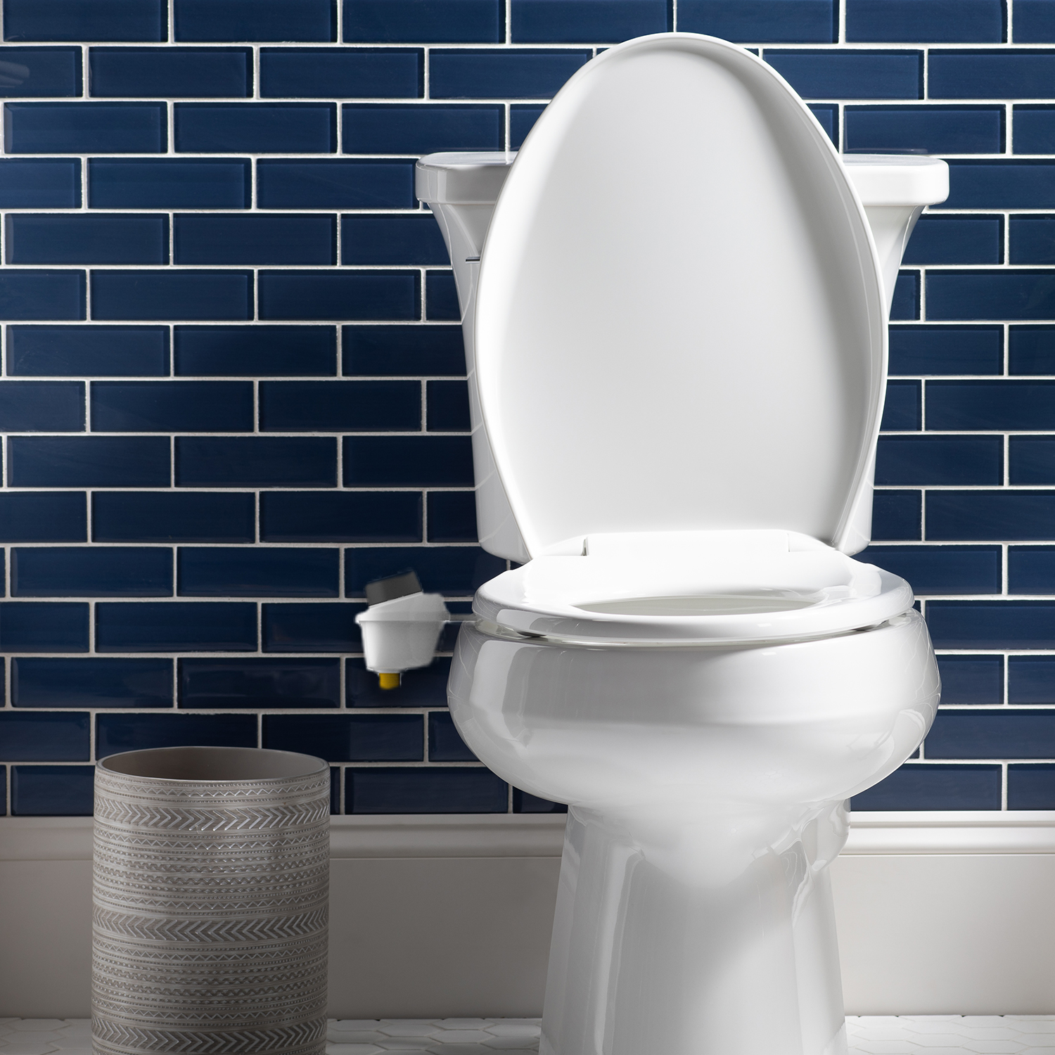 White toilet seat on blue tiles